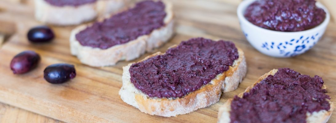 Black olive paté, or black olive paste, spread on bread is one of those lovely alternatives to the classic garlic and tomato bruchetta topping.