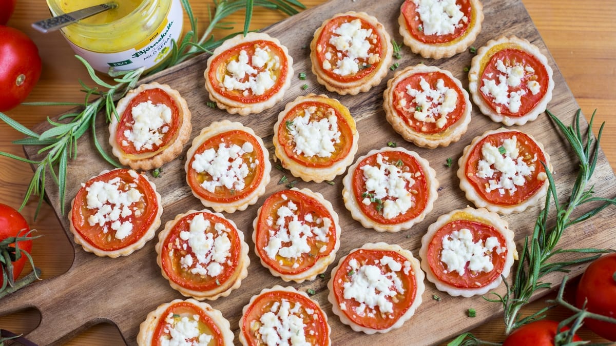 Overhead view of bite-sized tomato tarts.