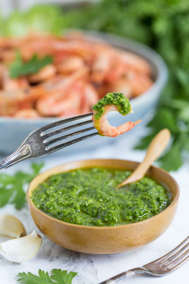 A small bowl with nordic pesto and a large bowl filled with smoked shrimp.