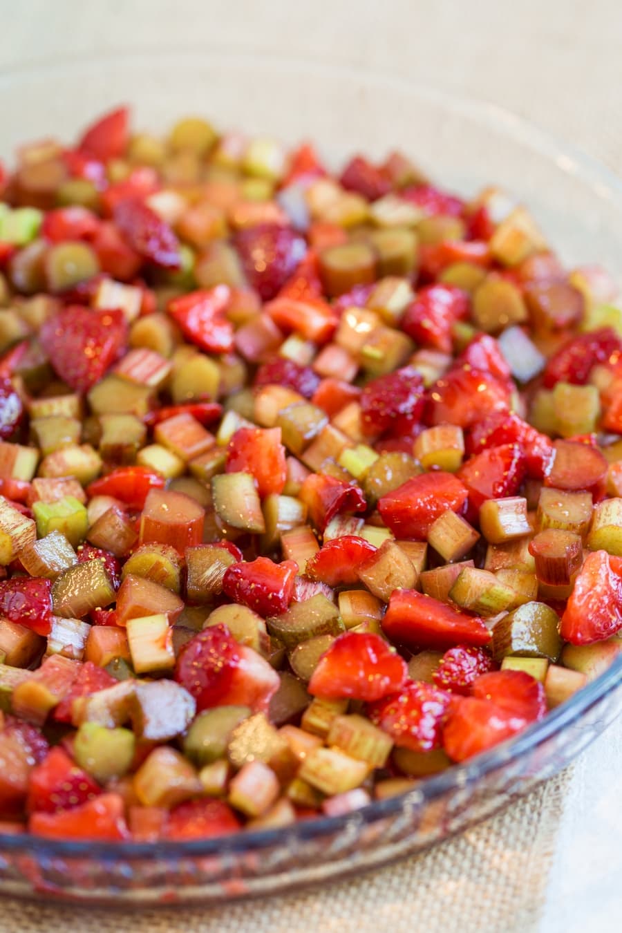 Diced strawberry and rhubarb over the bottom of a tart pan.