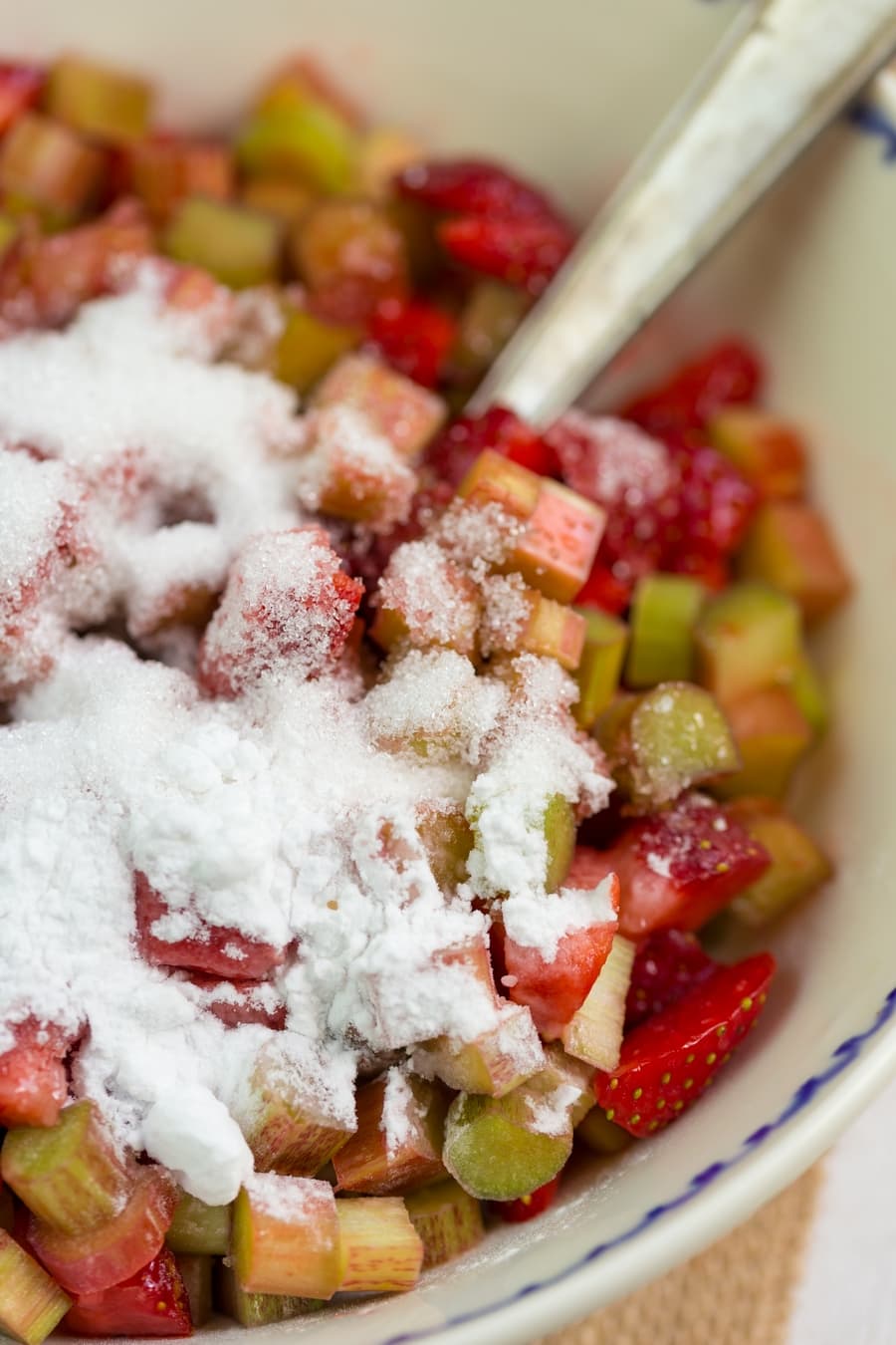 Strawberry rhubarb crisp base: sugar and starch added to diced fruits.