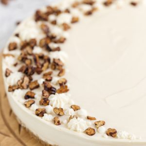 Closeup of roasted pecans on maple no-bake cheesecake.