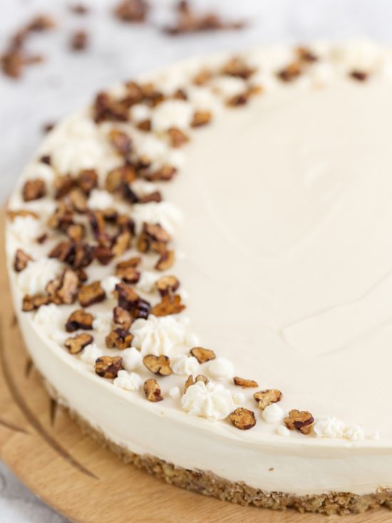 Closeup of roasted pecans on maple no-bake cheesecake.