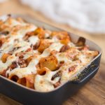 Baked pasta casserole sprinkled with parmesan.
