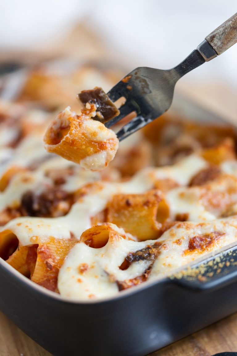 Fork lifting pasta and eggplant bit from casserole.