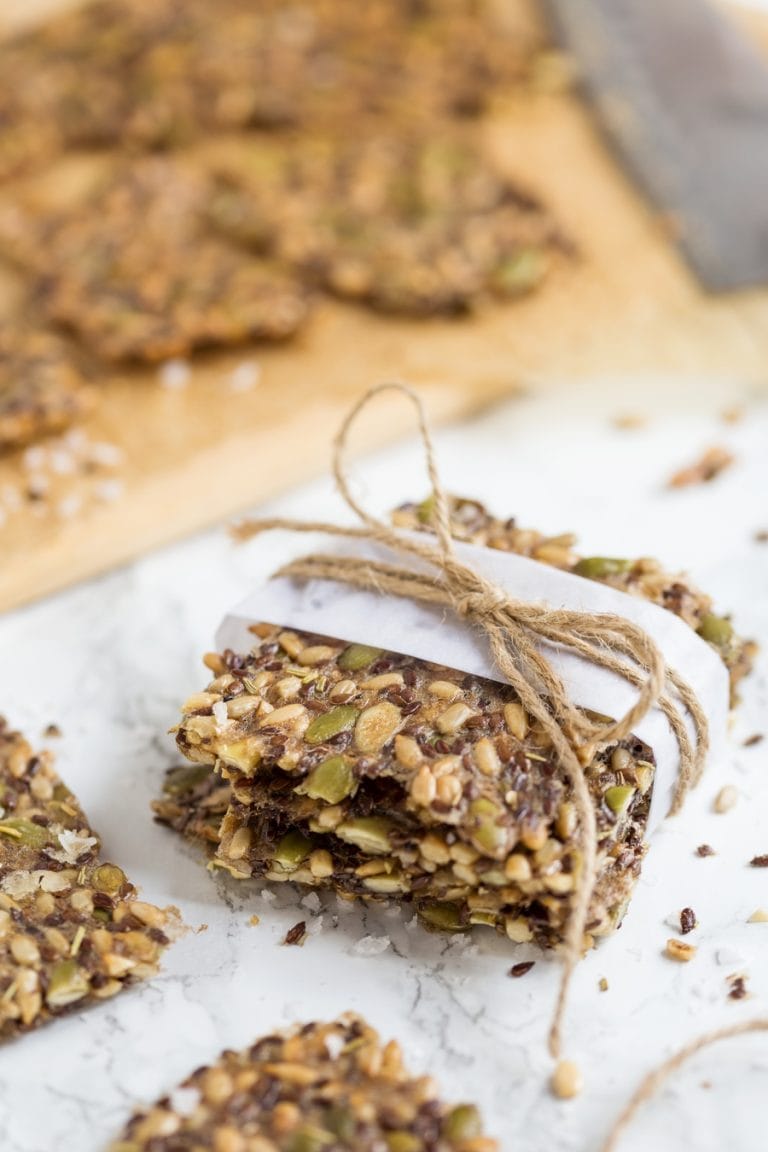 Seed crackers wrapped in white paper, with a jute twine ribbon.