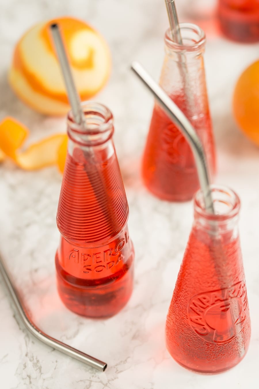 Campari spritz in Campari soda and Aperol soda bottles.