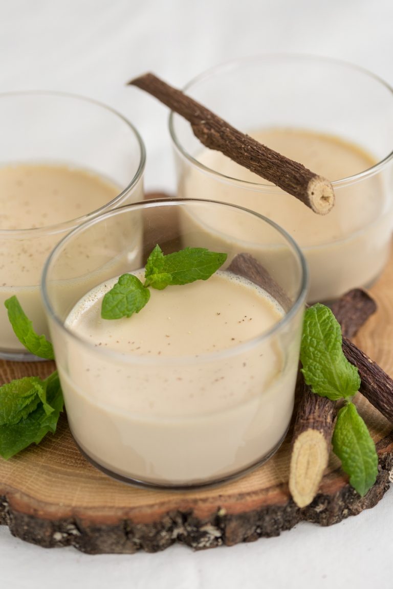 Closeup of liquorice panna cotta served in see-through glass.