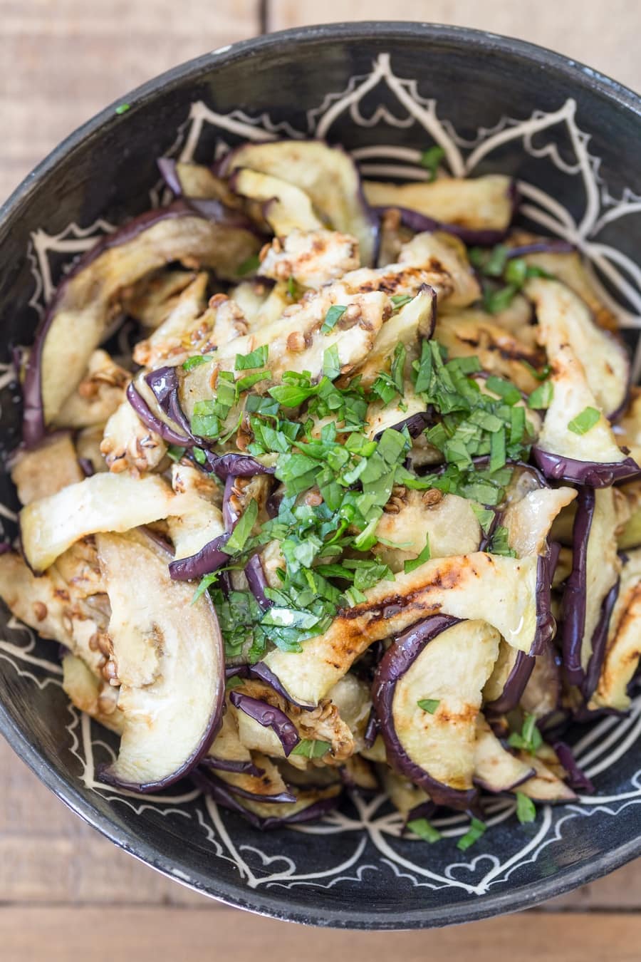 Grilled eggplant salad with olive oil and fresh mint.