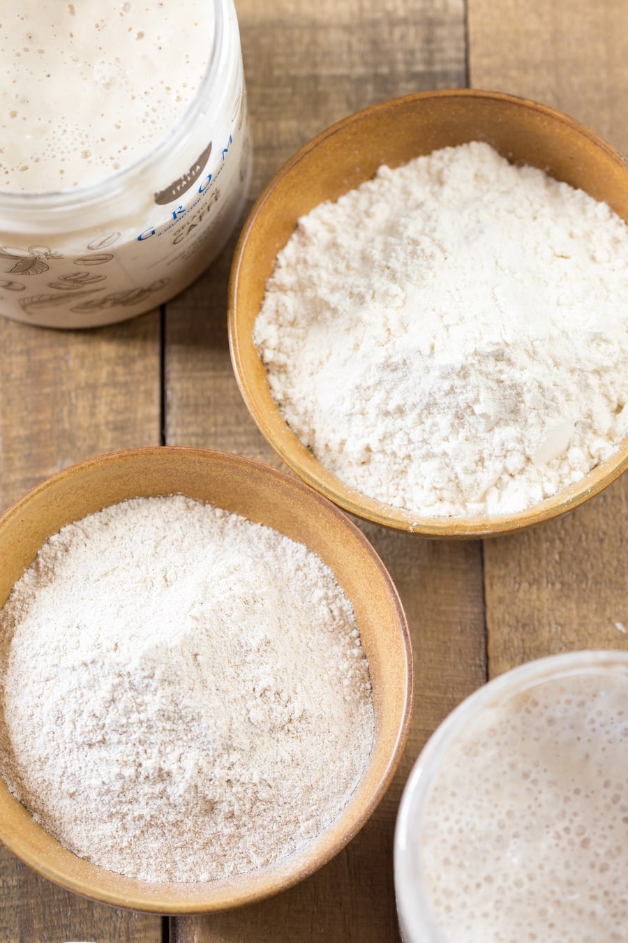 Two different types of flour in two bowls next to each other.