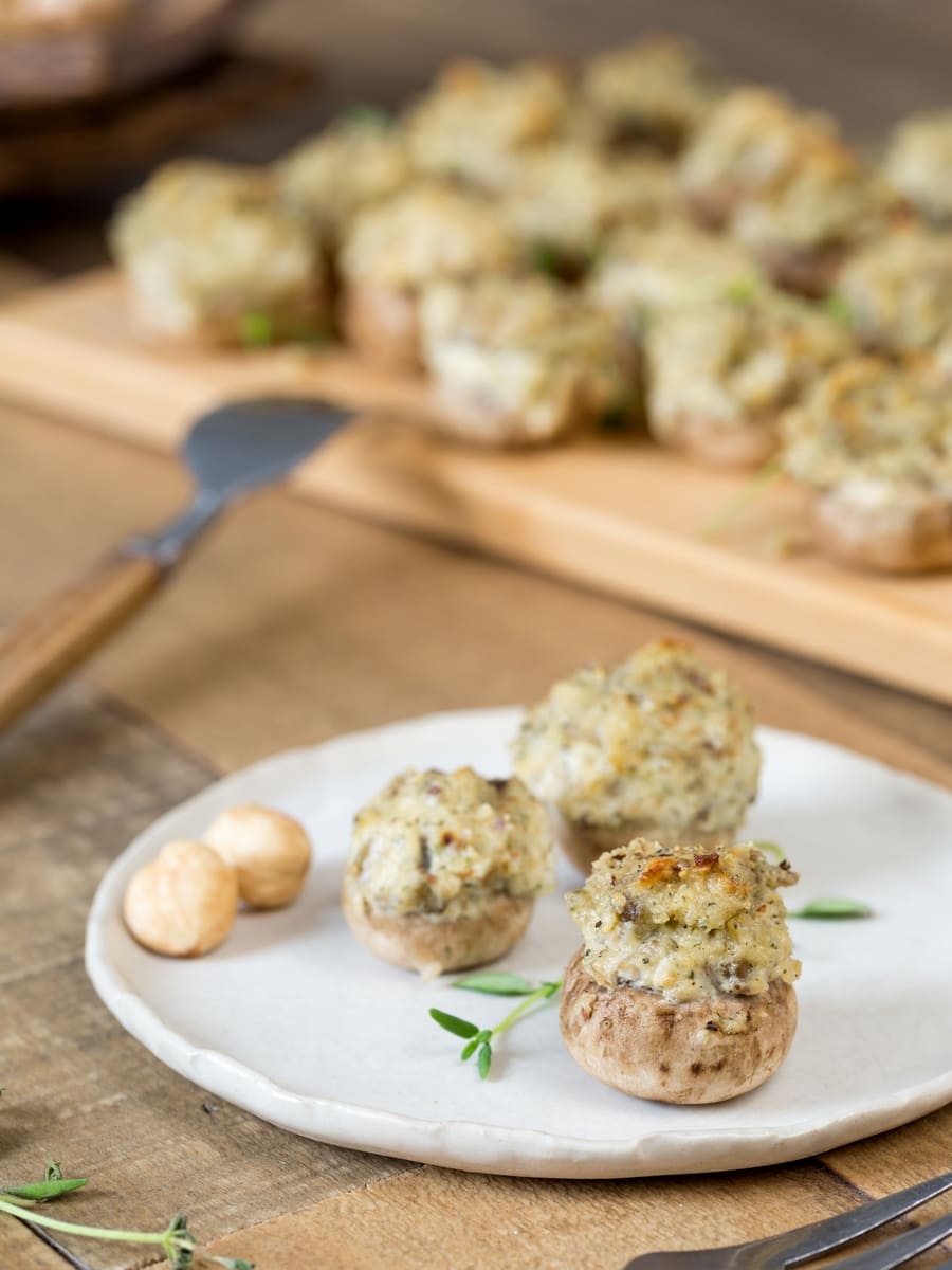 Hazelnut stuffed mushrooms served on a small white plate.