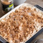 Baked rice with apples casserole sprinkled with ground cinnamon and sugar.