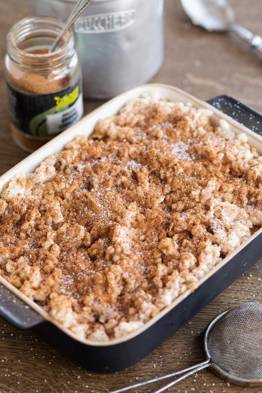 Sweet rice casserole sprinkled with ground cinnamon and sugar.