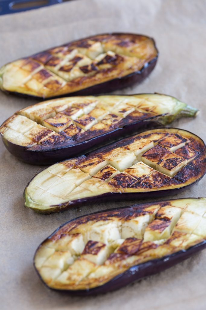 Blackened eggplants on an oven tray.