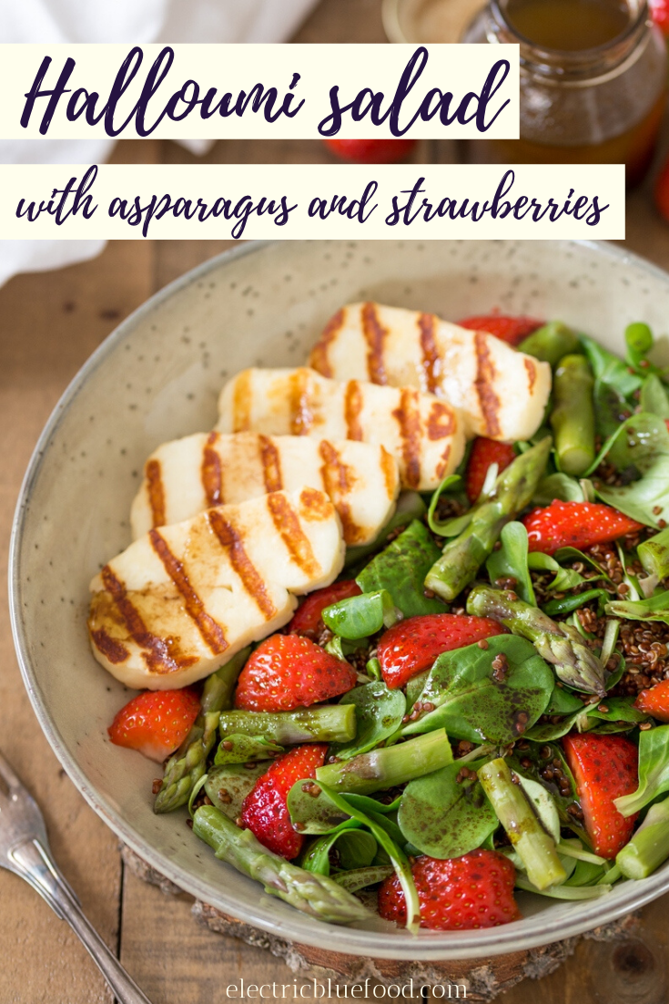 Asparagus and halloumi salad with strawberries and quinoa. A bed of green leaves and red quinoa topped with fresh strawberries, steamed asparagus and grilled halloumi. All seasoned with a simple balsamico vinaigrette. A healthy and balanced summer lunch.