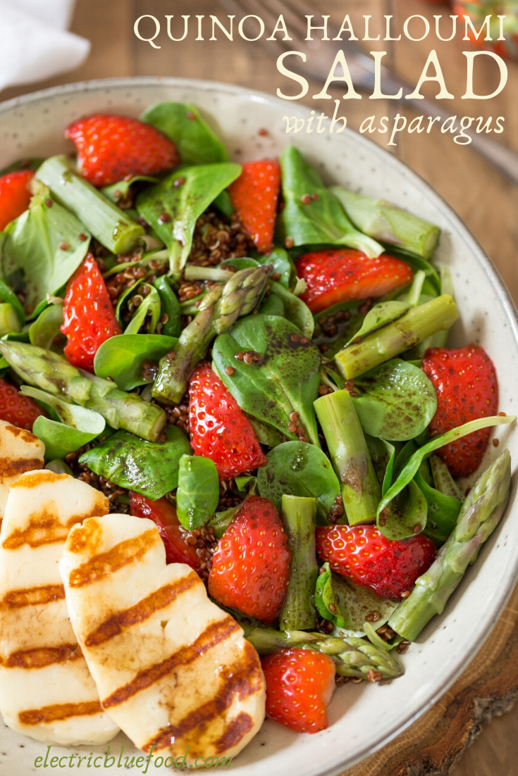 Asparagus and halloumi salad with strawberries and quinoa. A bed of green leaves and red quinoa topped with fresh strawberries, steamed asparagus and grilled halloumi. All seasoned with a simple balsamico vinaigrette. A healthy and balanced summer lunch.