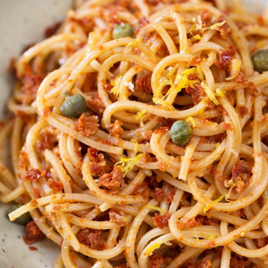 Spaghetti alla chitarra with red pesto, capers and lemon zest.