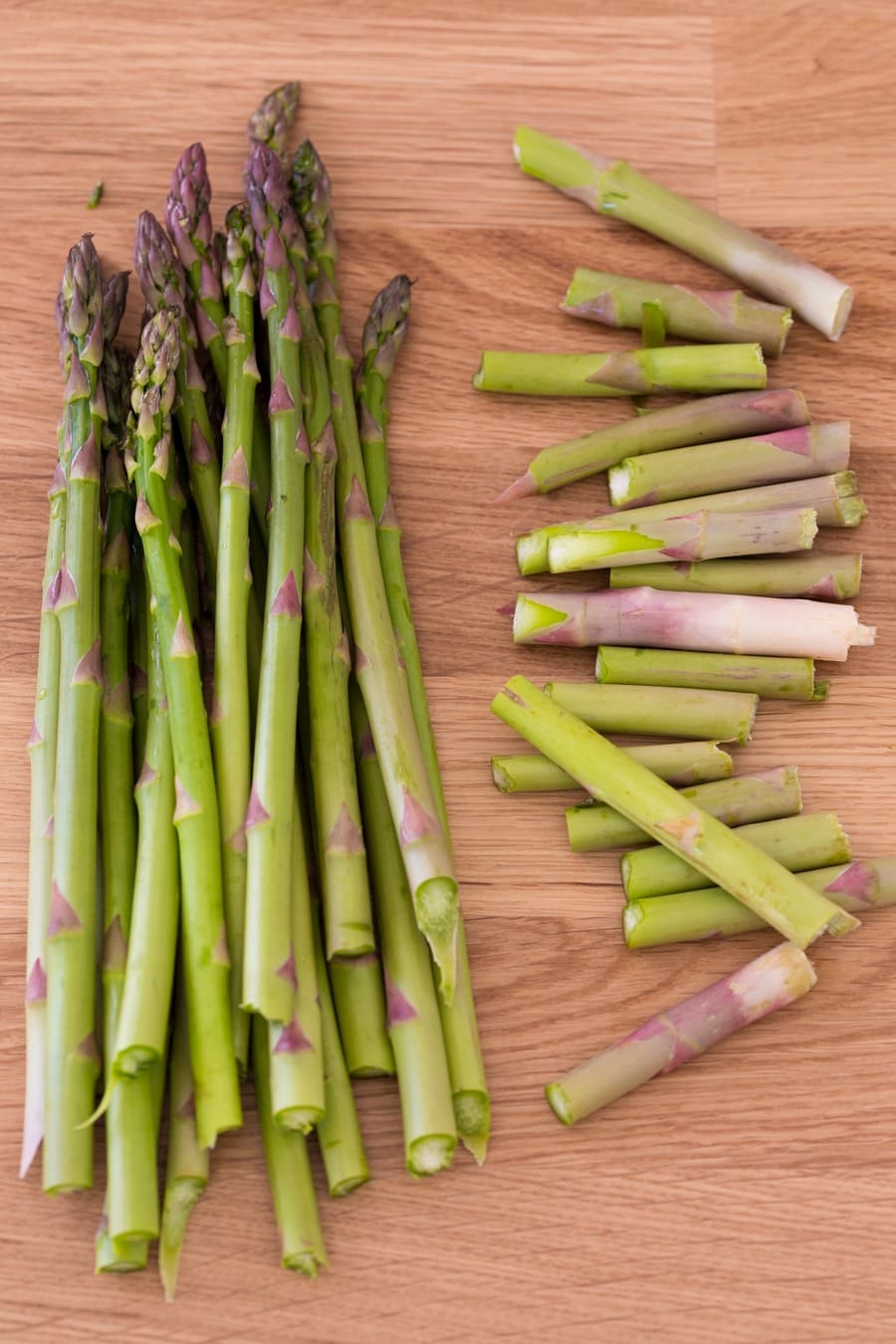 Asparagus stalks with woody ends separated.