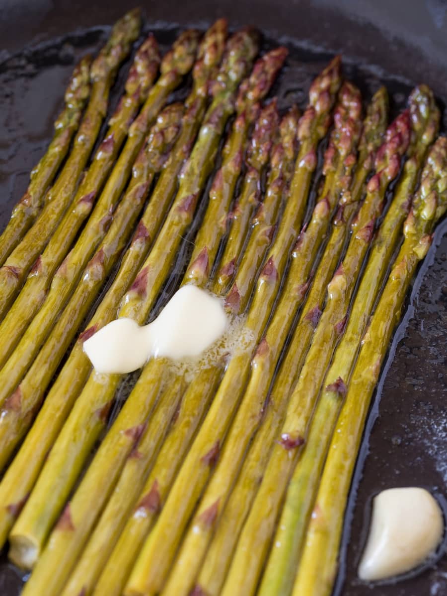 Little bit of butter melting over hot cooked asparagus.