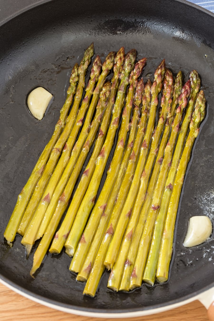 White wine asparagus in cast iron skillet.