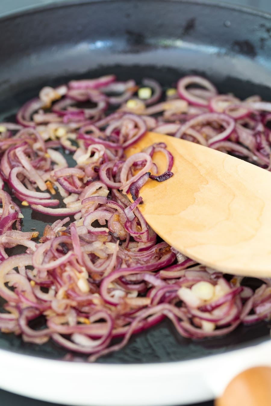 Sweating red onions in a cast iron skillet.