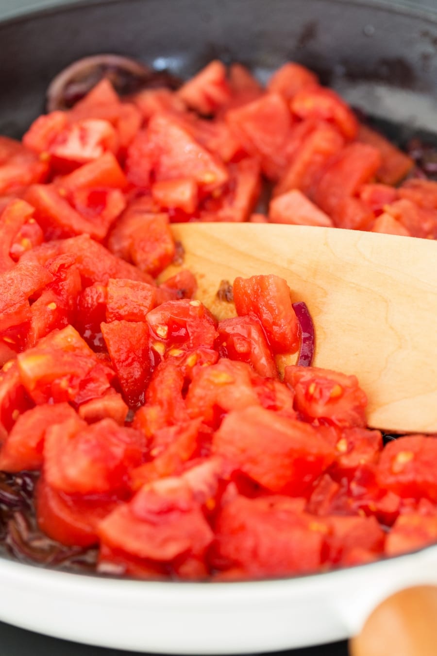 Chopped fresh tomatoes added to red onion soffritto.