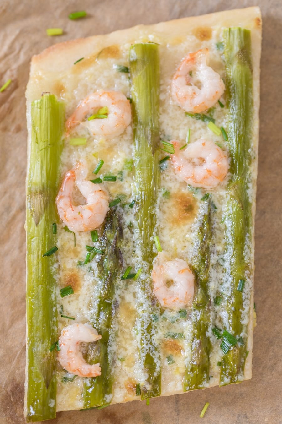 Slice of shrimp asparagus flatbread with zesty mascarpone sauce.