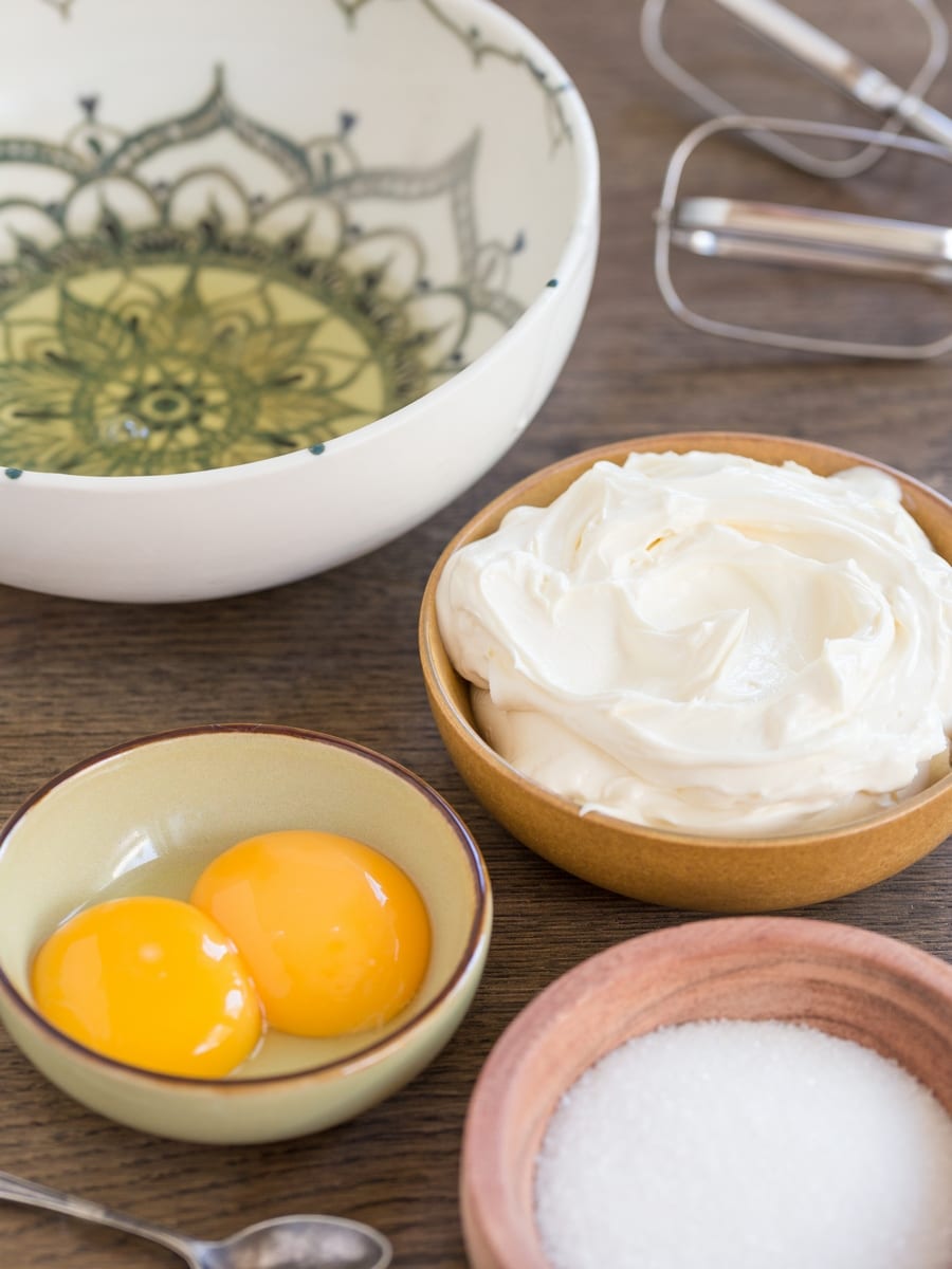 Sugar, mascarpone, egg whites and yolks separated. The ingredeints to make tiramisu mascarpone cream.