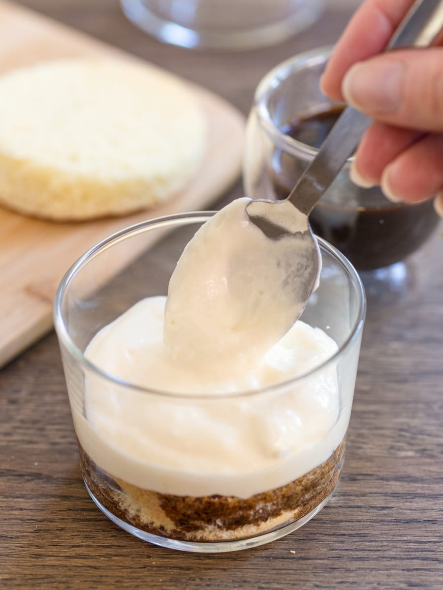 Tiramisu in a glass preparation: adding mascarpone cream to coffee-soaked sponge cake.