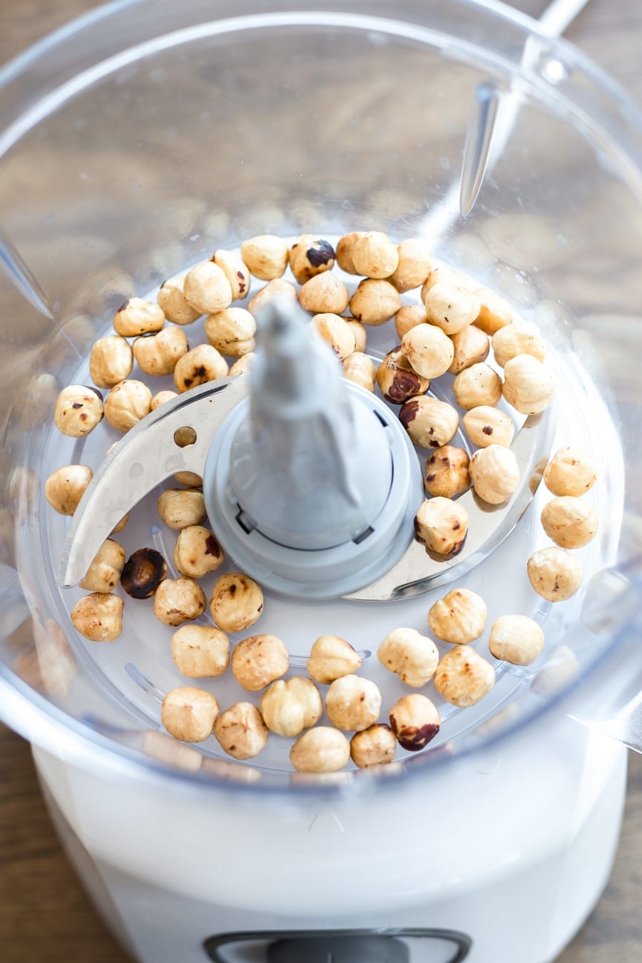Toasted hazelnuts in a food processor.