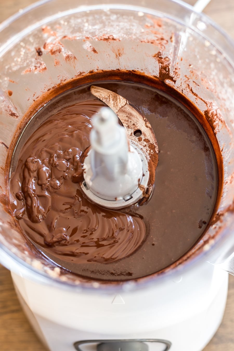 Melted dark chocolate is added to cocoa hazelnut paste to make homemade nutella.
