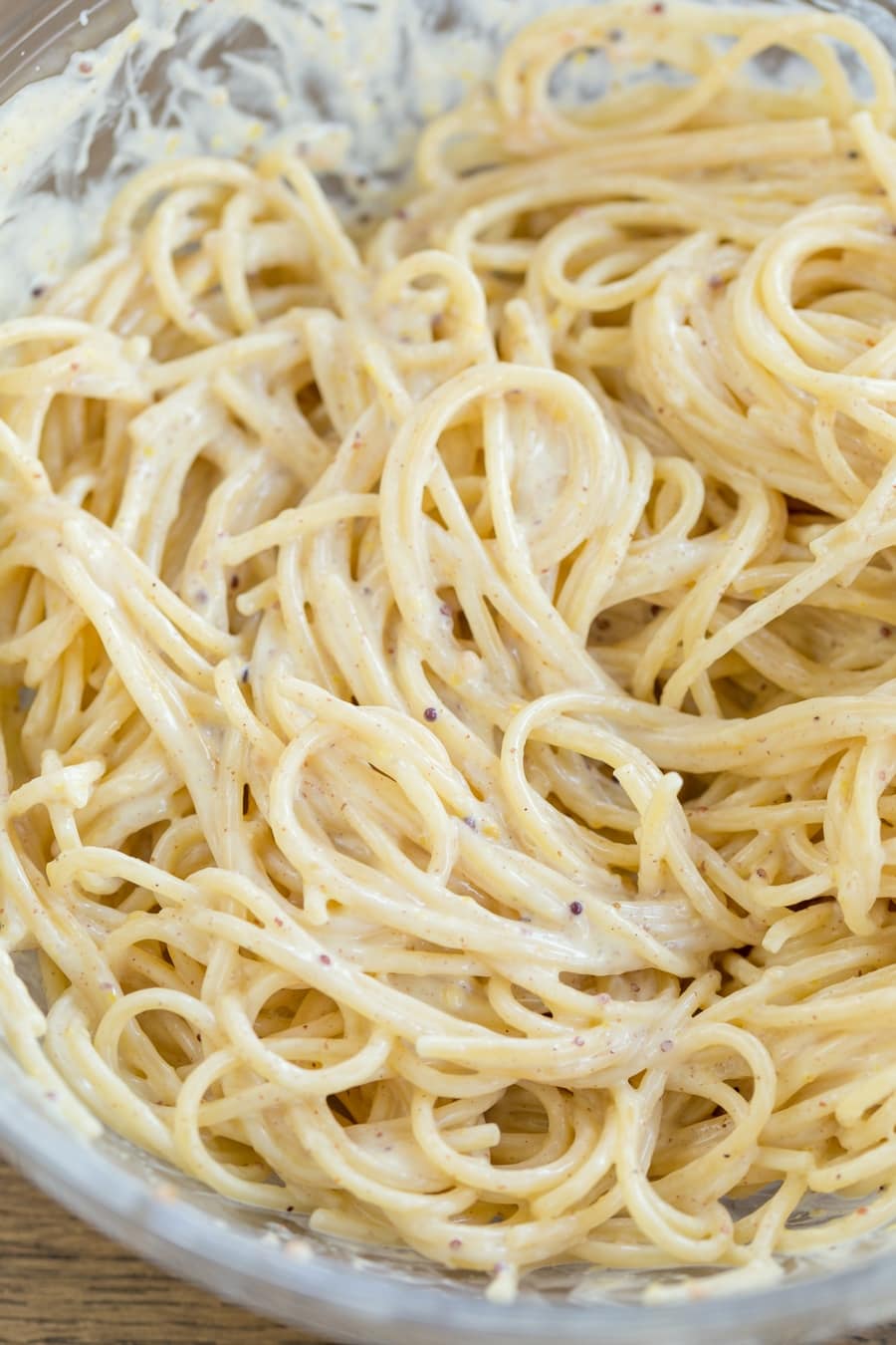 Spaghetti with creamy mustard sauce in a bowl.