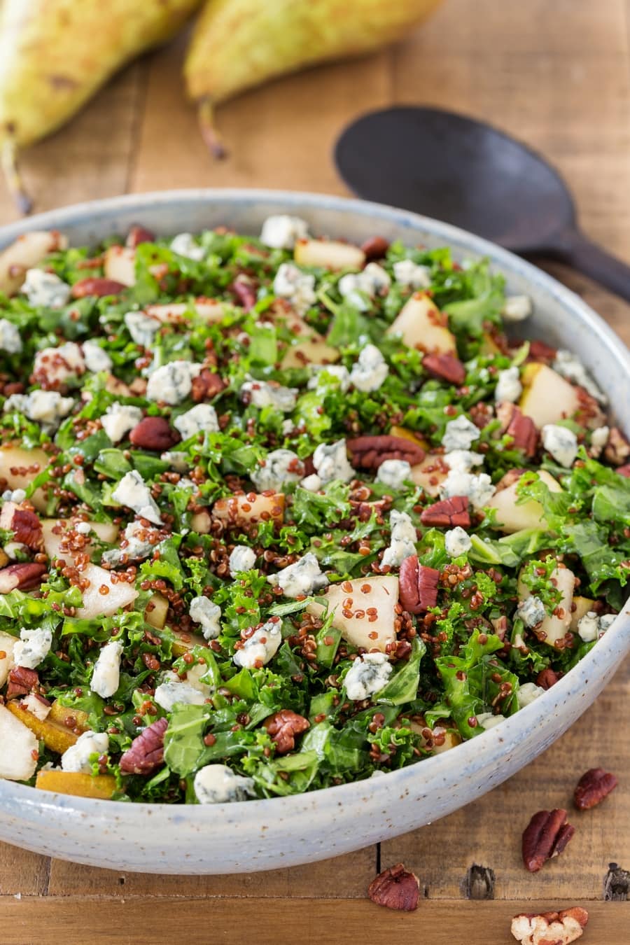 Pear and blue cheese kale and quinoa salad in a bowl.