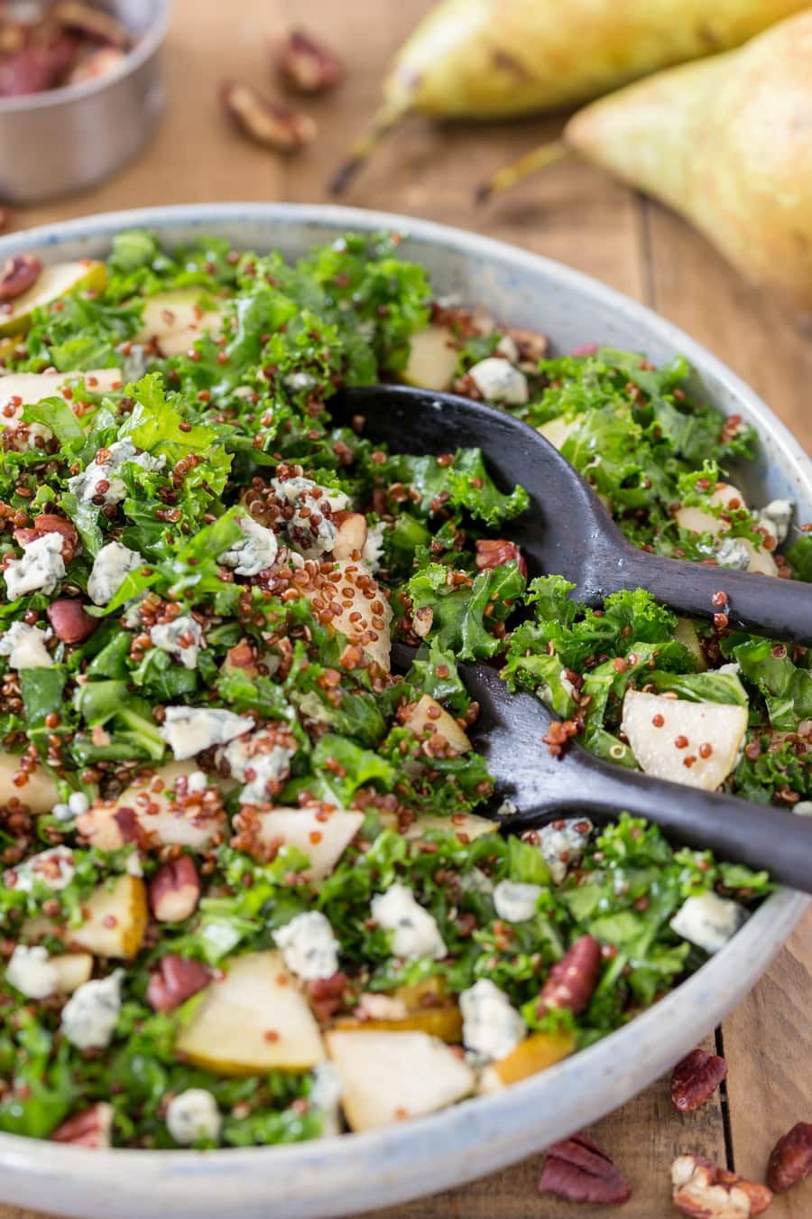 Bowl of kale quinoa salad with pear and blue cheese.