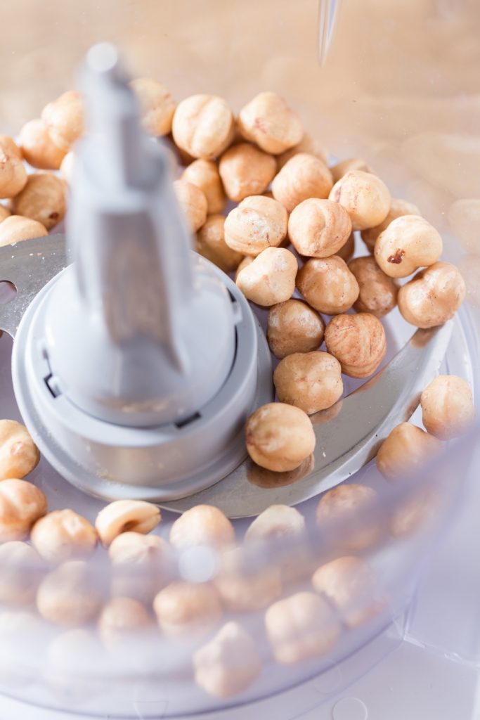 Whole hazelnuts in a food processor.