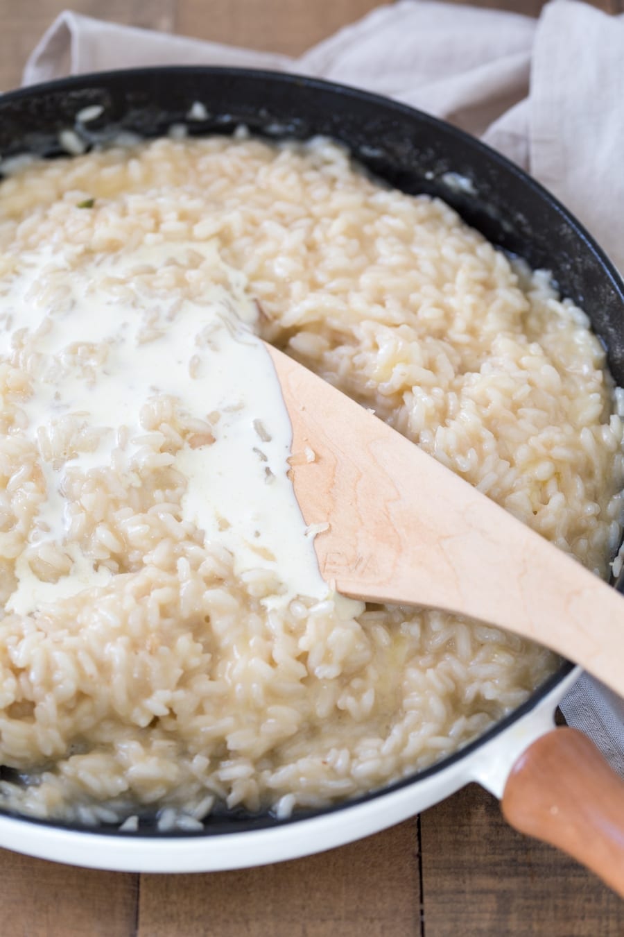 Zucchini cheddar risotto preparation: cream added to the rice.