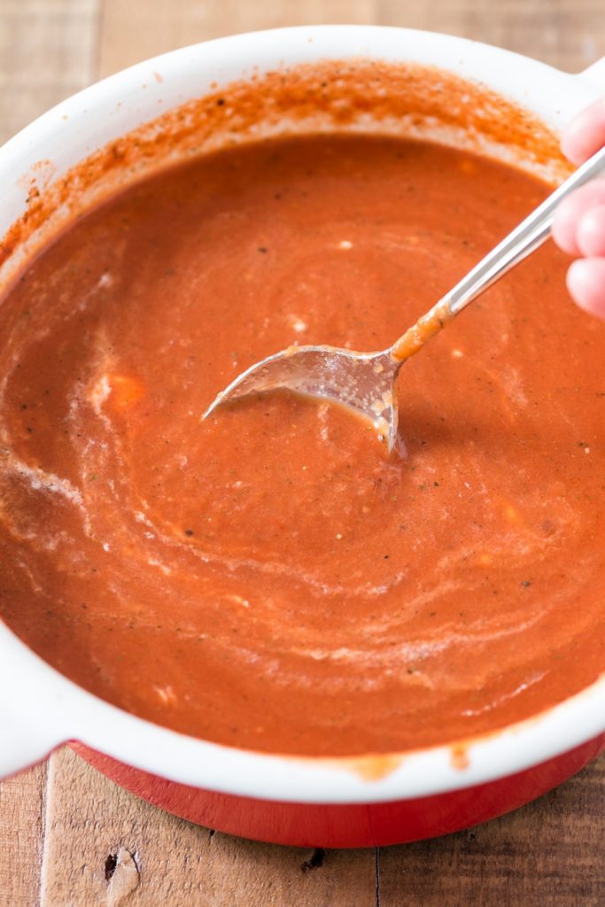 Mixing the cream into Polish tomato soup.