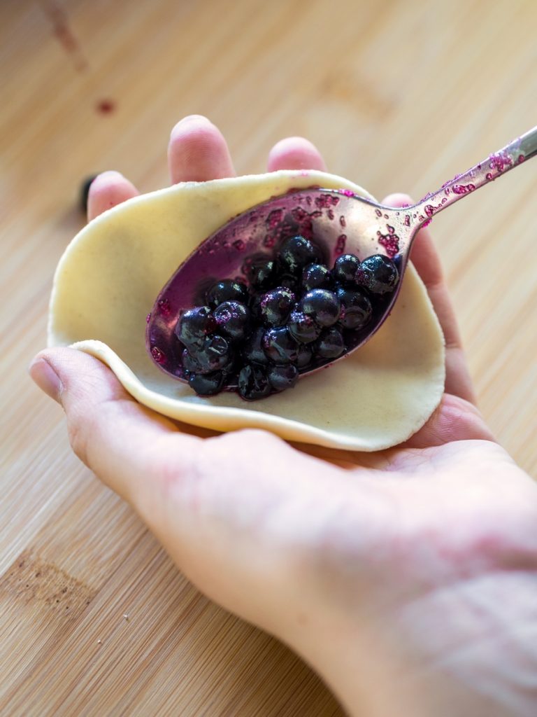 Hand-filling of blueberry pierogi.