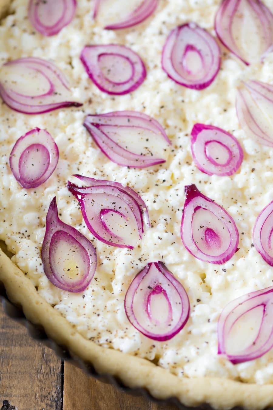 Sliced pearl onions over cottage cheese filling.
