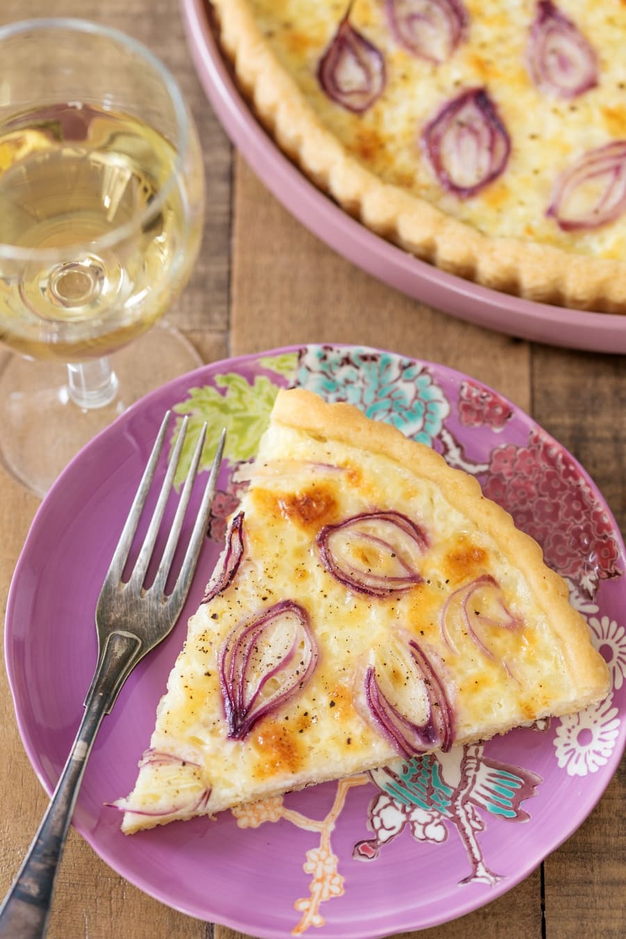 Slice of pearl onion cottage cheese tart.