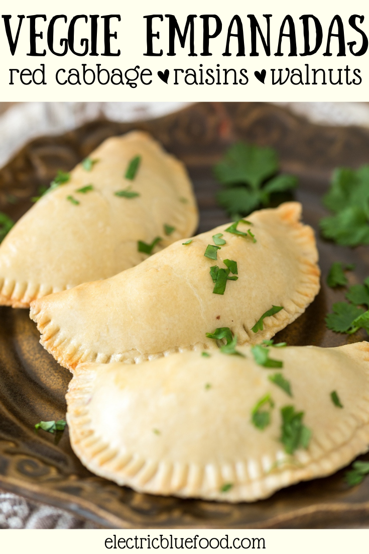 Veggie empanadas: a vegetarian version of the popular Argentine turnovers. A filling made of sautéed red cabbage, red onion, raisins and walnuts is enclosed inside a flaky pastry shell to make a delicious veggie dish.