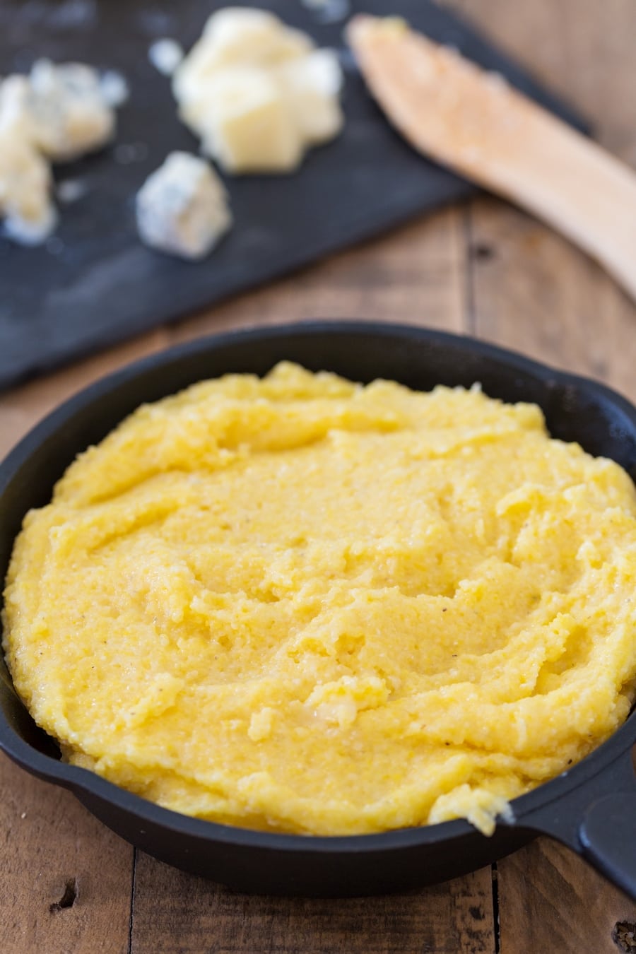 Skillet of polenta filled with cheese.