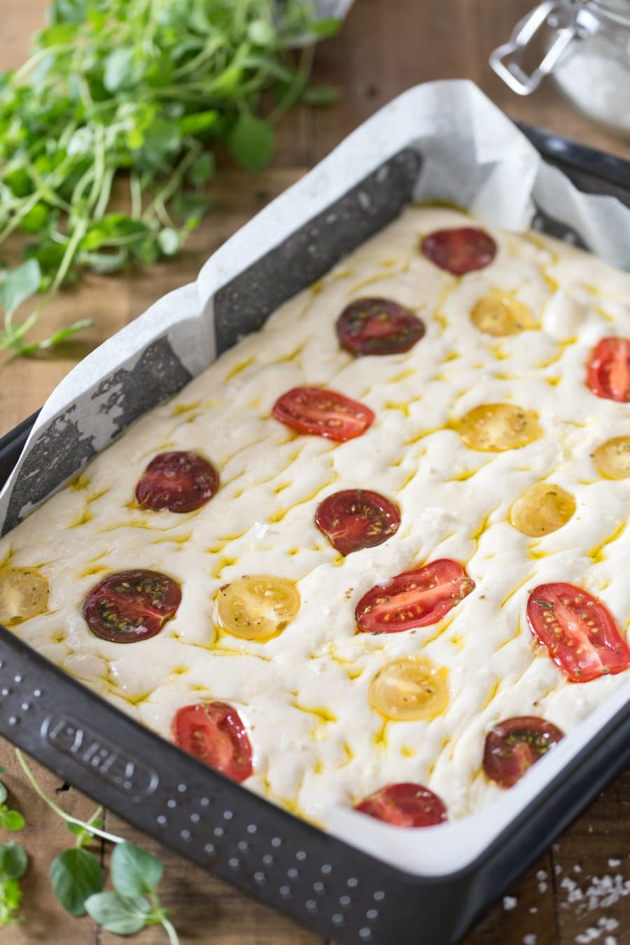 Poolish focaccia bread with cherry tomatoes unbaked.