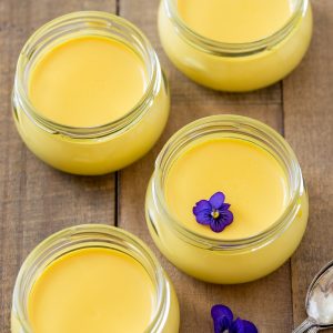 Saffron panna cotta in small glass jars.