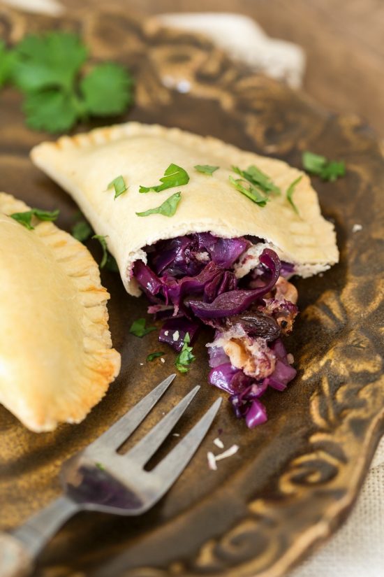 Veggie empanadas showing the filling made with red cabbage, onion, raisins and walnuts.