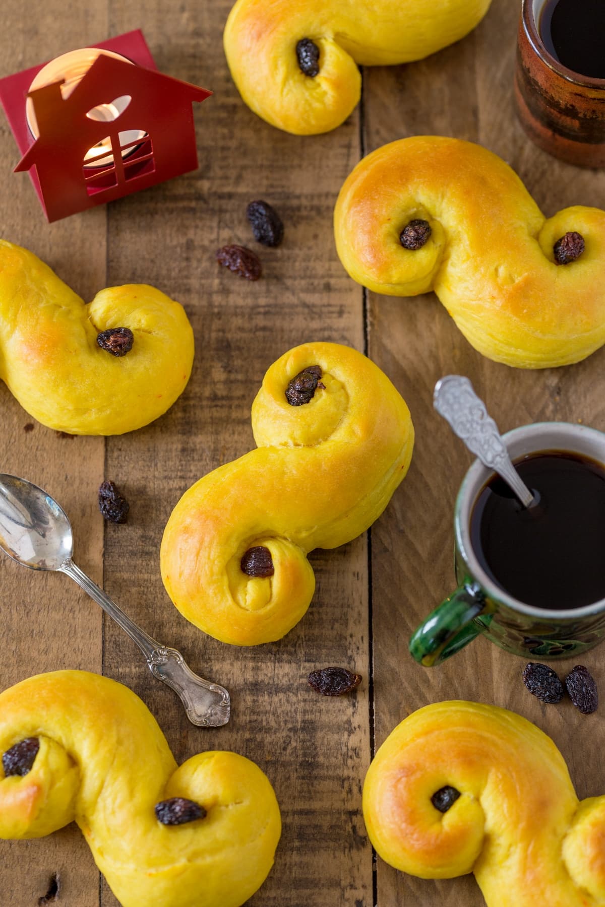 Lussebullar, coffee and a candle on a coffee table.