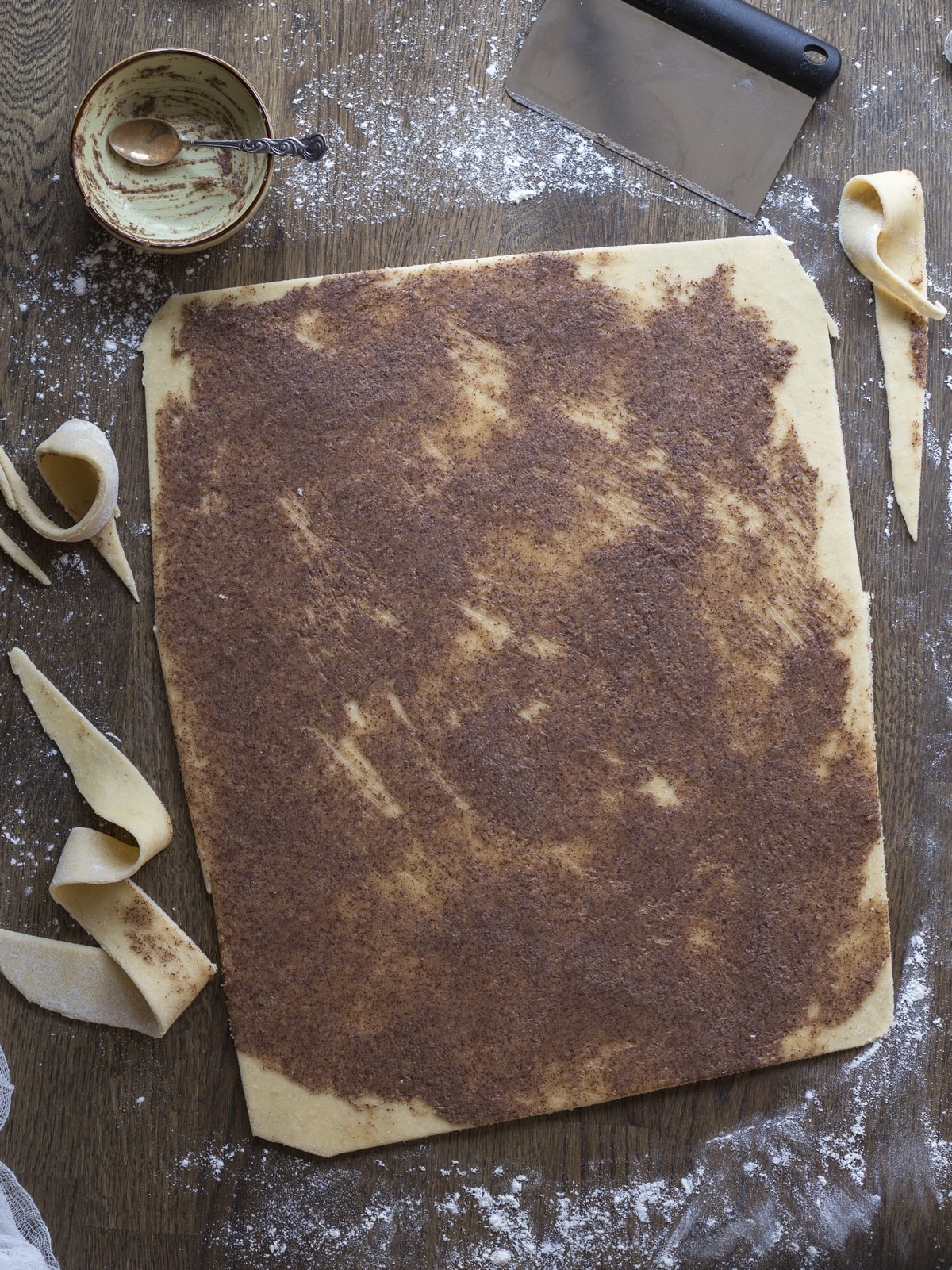 Square of dough with cinnamon filling to be rolled up to make cinnamon buns.