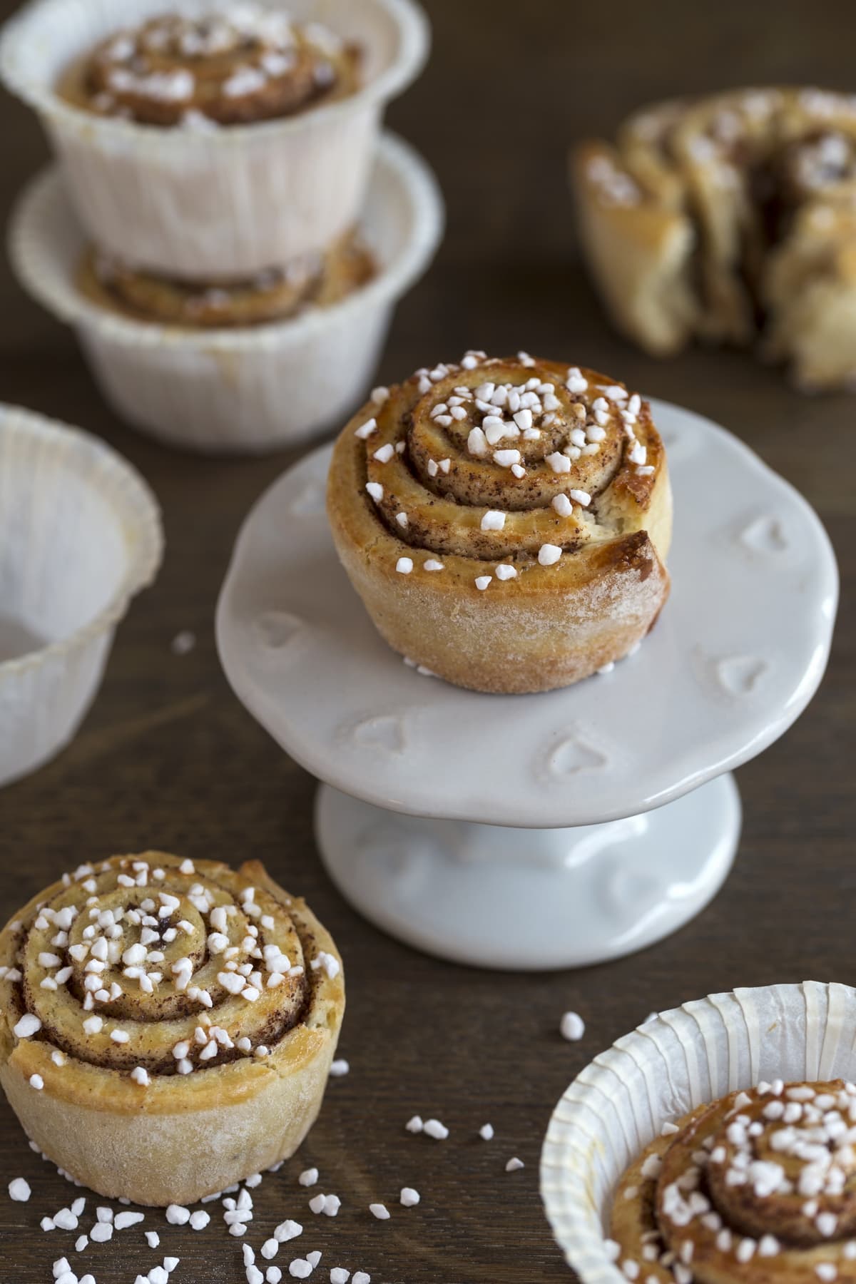 Mini cinnamon bun on a cupcake stand.