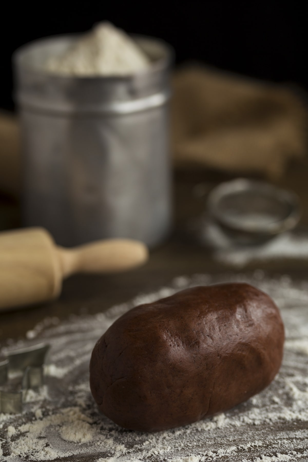 Cookie dough ball on floured surface.