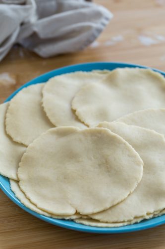 Flat dough discs to be used for empanadas.